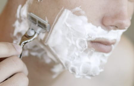 Man shaving his face