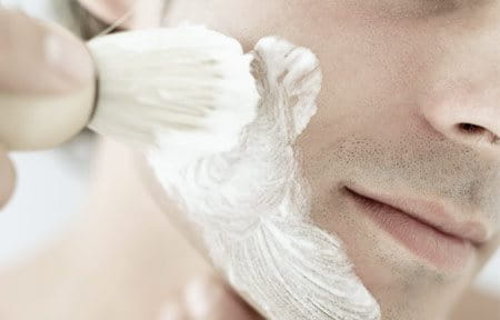 Man applying shaving cream on his face