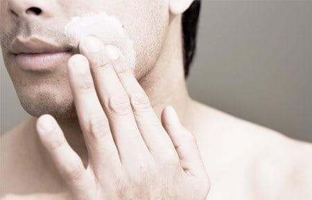 Man gets facial treatment with sponges