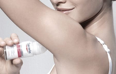 Woman uses Eucerin 48 h Anti-Transpirant Roll-On