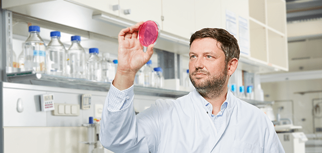 A scientist inspecting a skincare formula in Eucerin lab