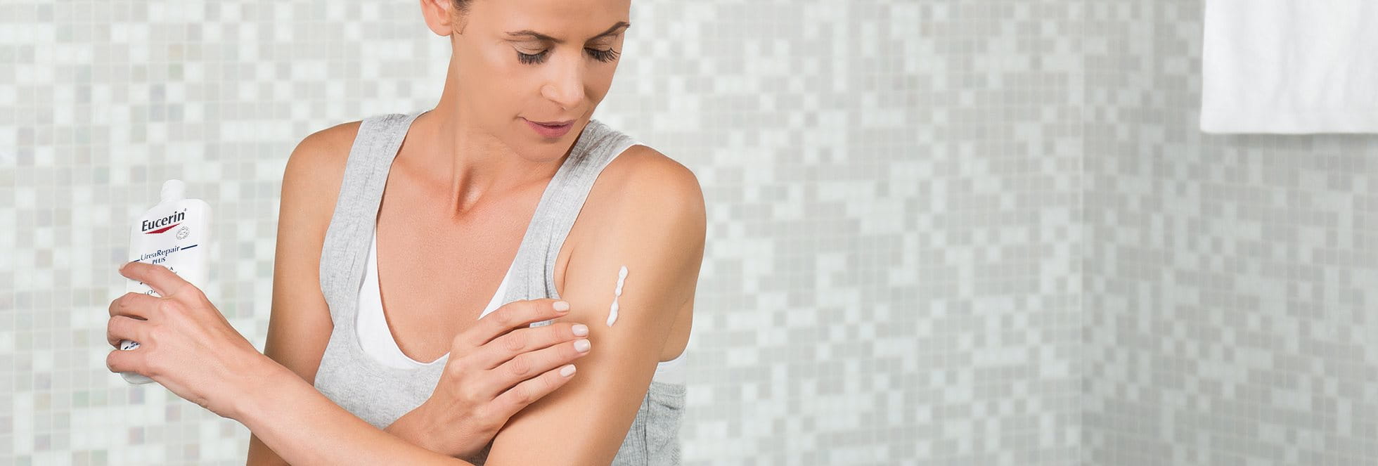 Woman applying product to her arm