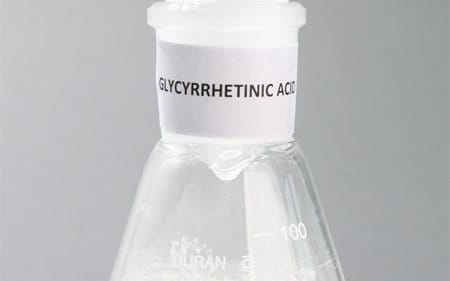 Laboratory flask labeled Glycyrrhetinic Acid.