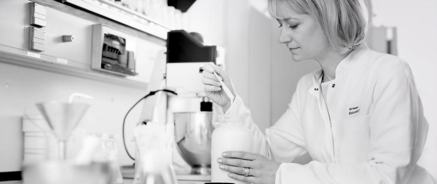 Scientist in a lab coat conducting research in a laboratory.