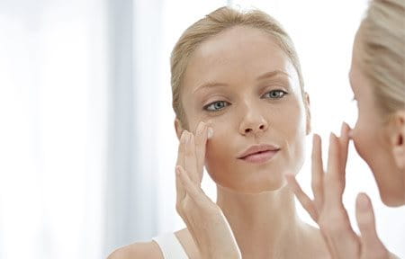 Women Applying Gel On Her Face 