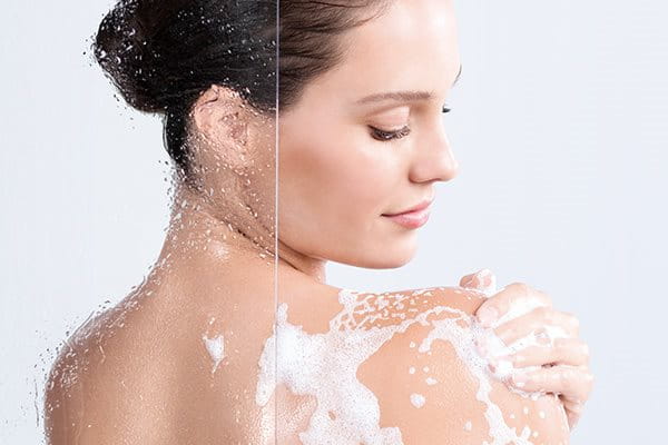 Woman using pH5 Soft Shower oil