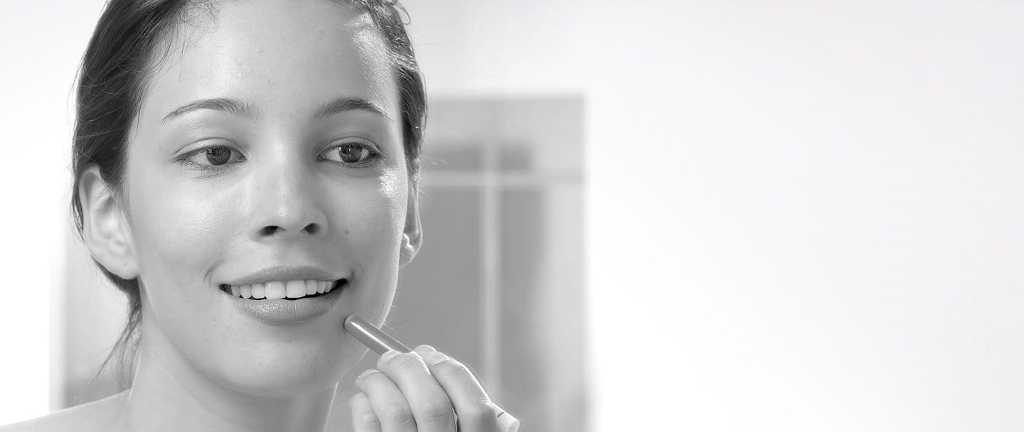 Young woman using Eucerin DermoPURIFYER Cover Stick