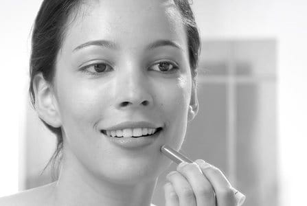 Young woman using Eucerin DermoPURIFYER Cover Stick