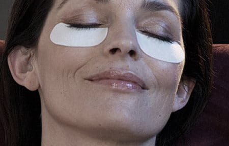 Woman using eye patches