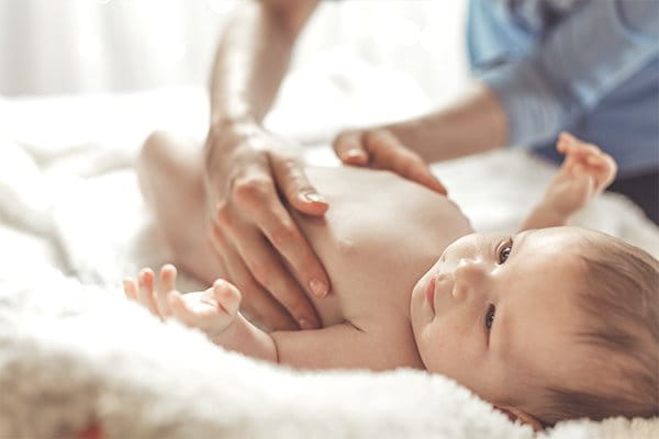 Baby being moisturized by their mother