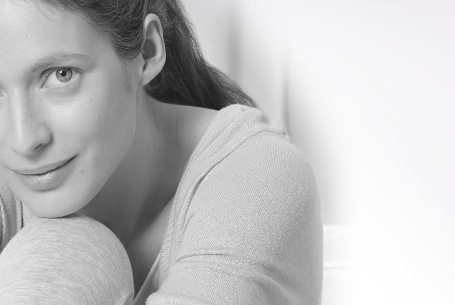 Woman leaning her head on her knee.