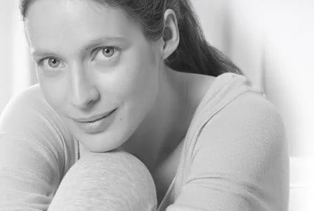 Woman leaning her head on her knee.