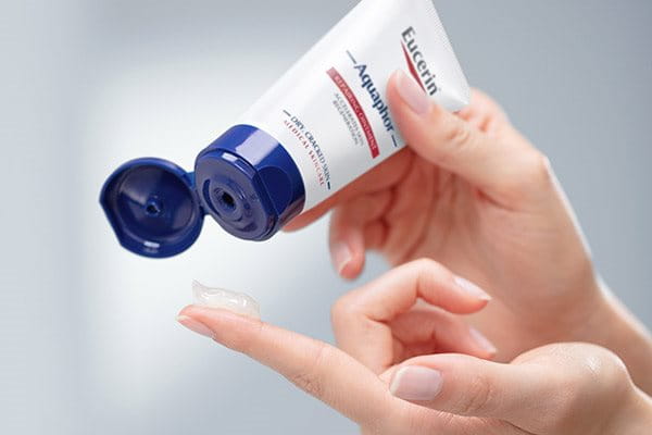 Woman using Eucerin Aquaphor creme