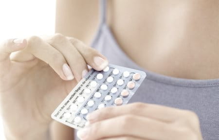 Woman with pills in her hands