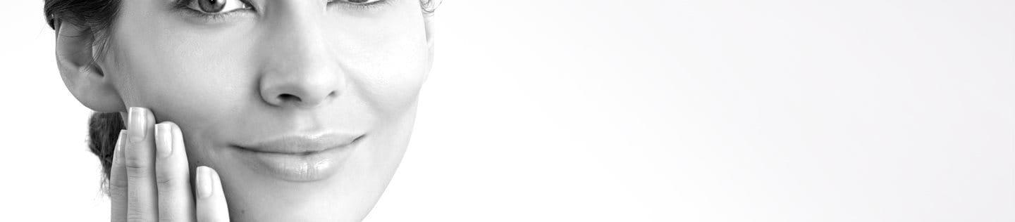 Middle-aged woman touching her right cheek with hand