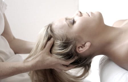 A woman receiving a scalp massage