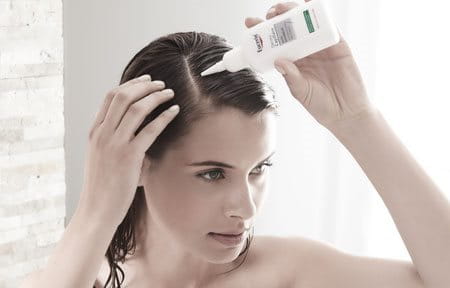 Woman using scalp treatment