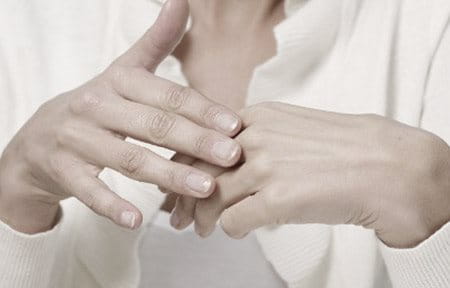 Two female hands touching each other.