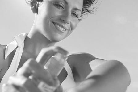 Woman applying sunscreen on her arm