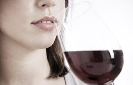 Woman drinking a glass of red wine.