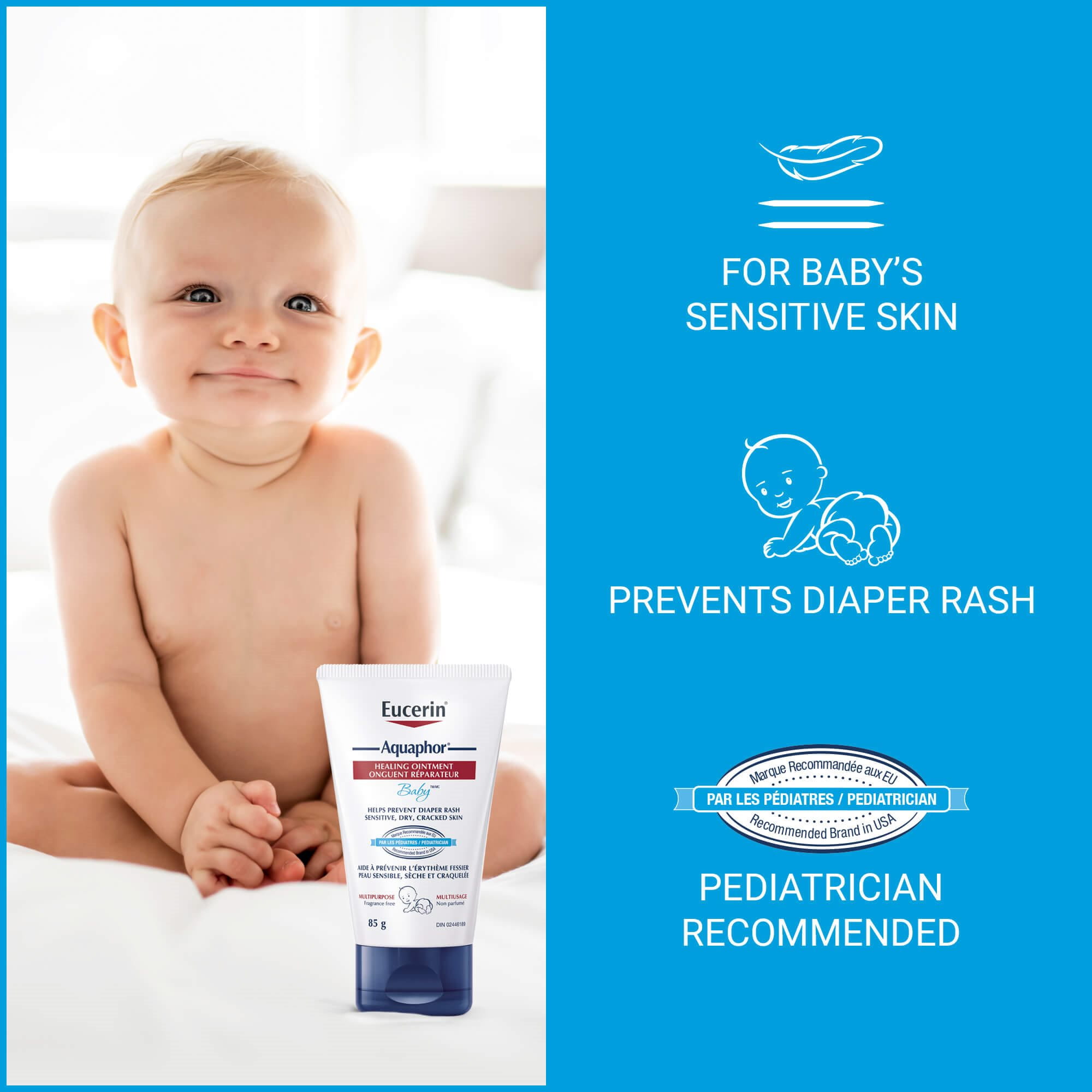 View of a smiling baby with Eucerin Aquaphor healing ointment product in front with a bedroom in the background.
