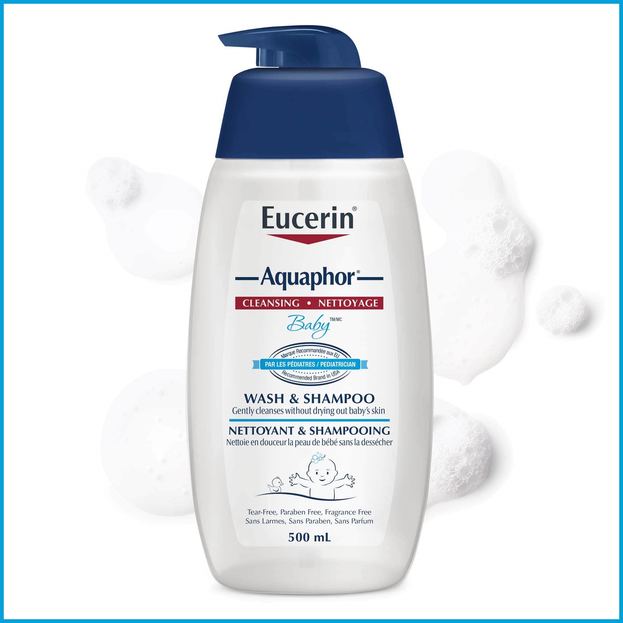 Bouteille de nettoyant et shampooing Eucerin Aquaphor Baby 500 ml avec éclaboussures du produit, sur fond blanc.