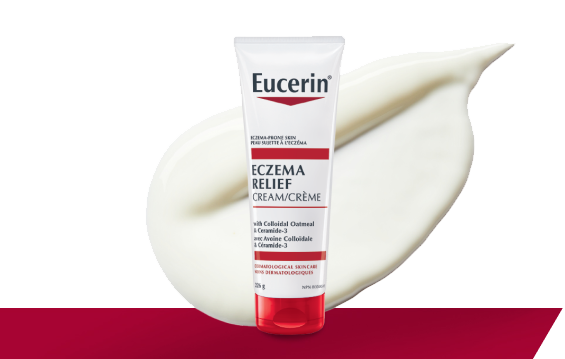 Photo de l’emballage de la Crème Eczema Relief avec une goutte de texture crémeuse à l’arrière-plan