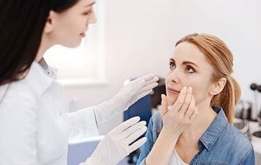 Woman being observed by a doctor