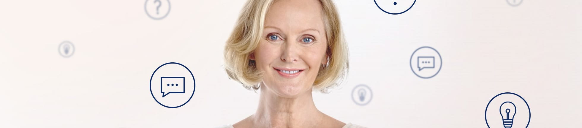 An elderly woman surrounded by bubbles of question marks and light bulbes