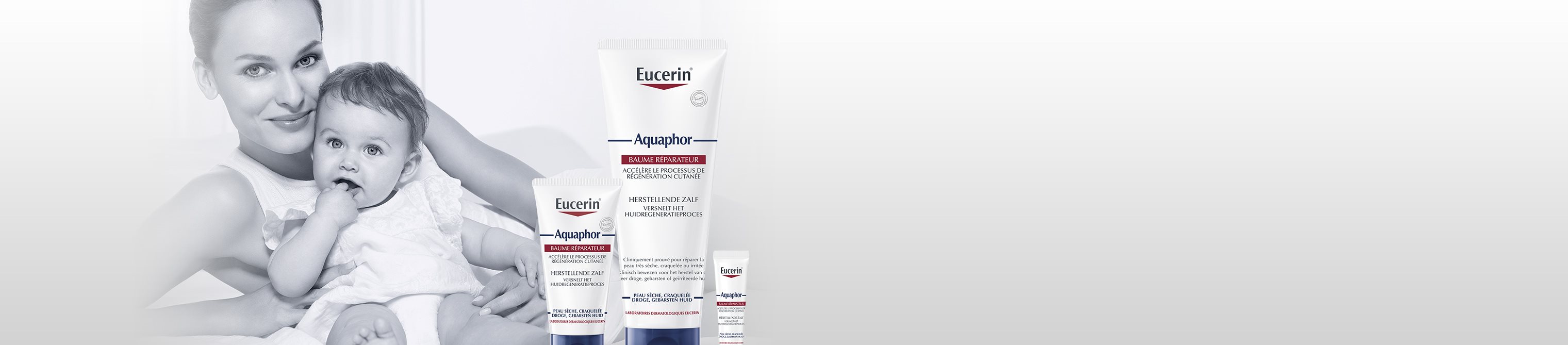 The product range Aquaphor with a mother holding a baby in the back