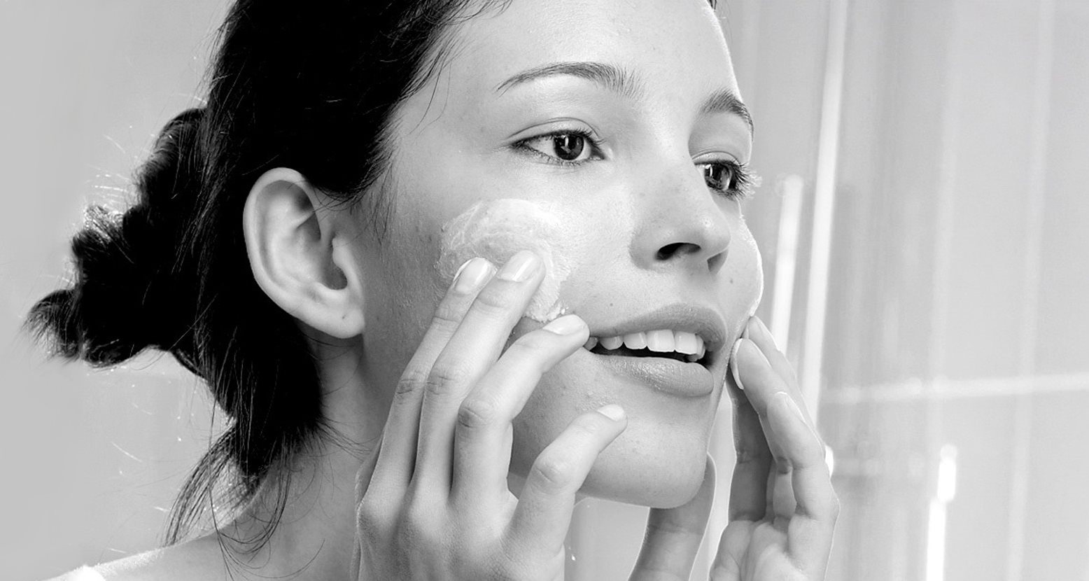 woman cleansing acne skin