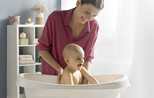 žena kupa dijete u kadici