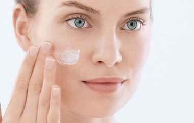 Applying cream on face
