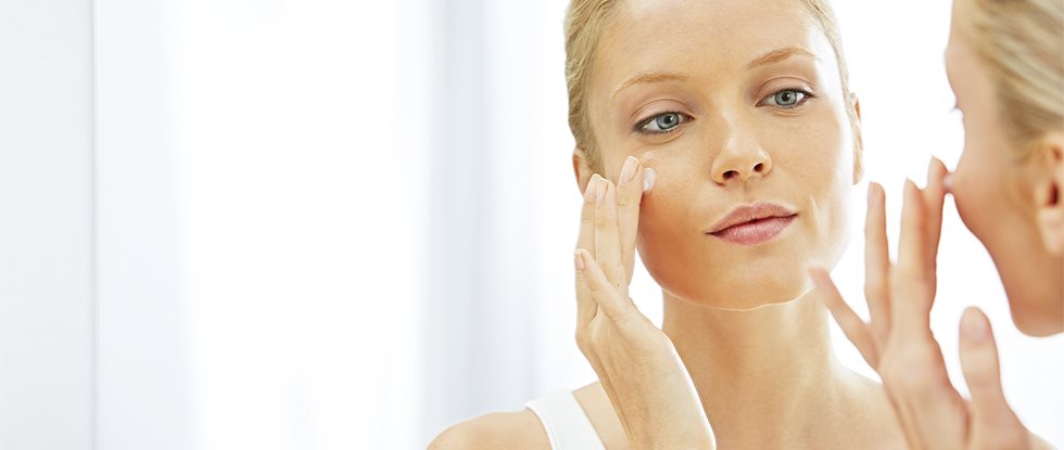 Woman treating acne face