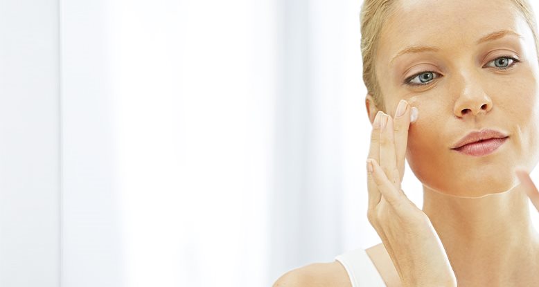 Woman treating acne face