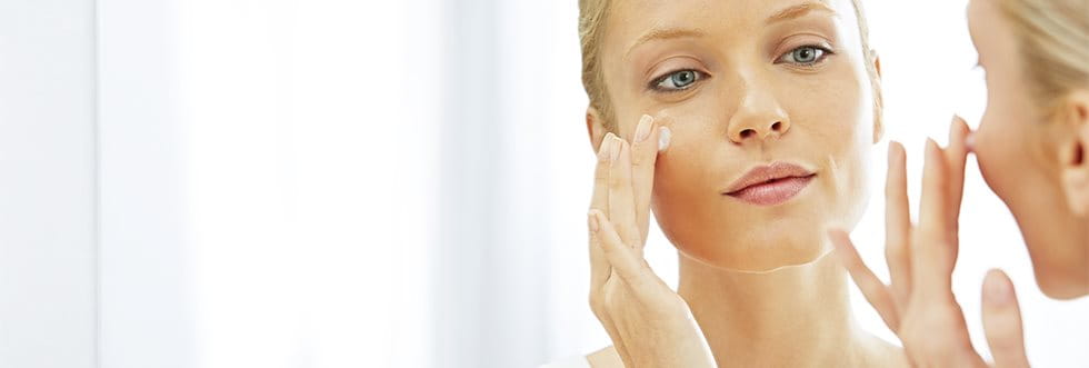 Woman treating acne face