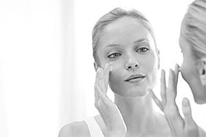 Woman treating acne face
