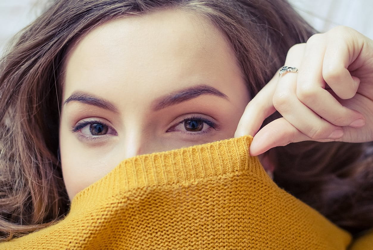 Woman feeling stressed while looking at laptop