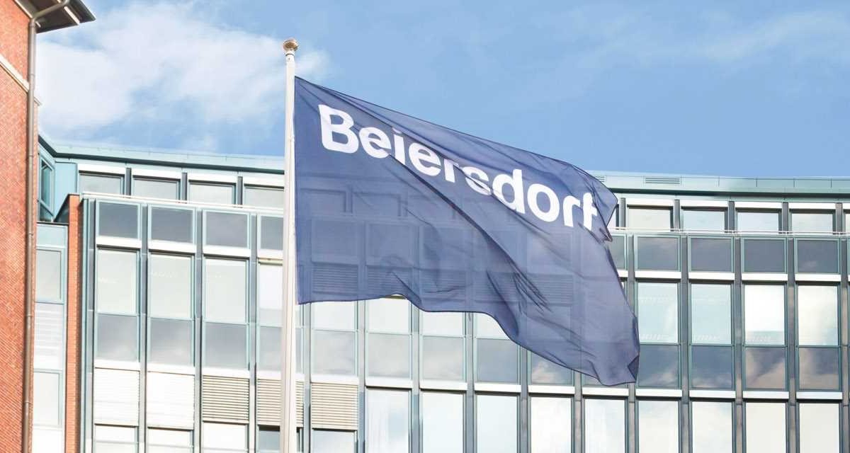 The Beiersdorf head office in Hamburg, in front of it the Beiersdorf company sign.