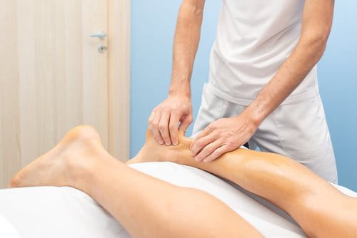 Person receiving massage on their achilles tendon