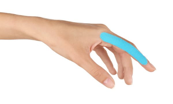 Linker Zeigefinger einer Frau mit blauem Tape
