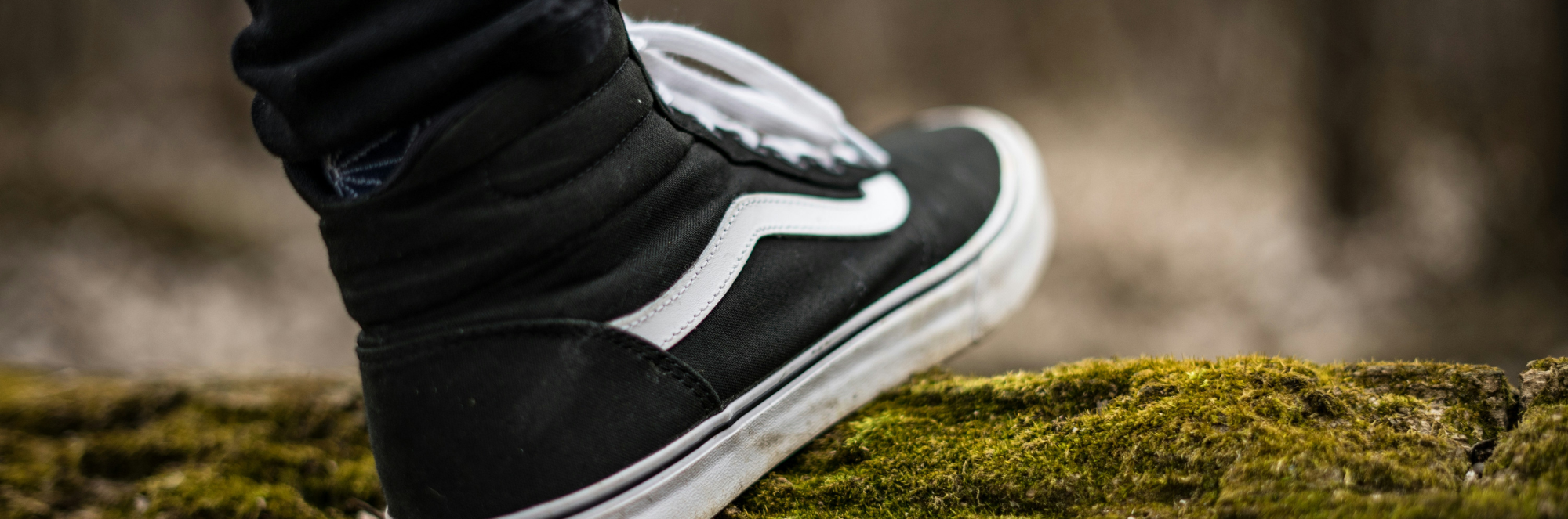 Close up shot of a persons shoe while they are walking in nature