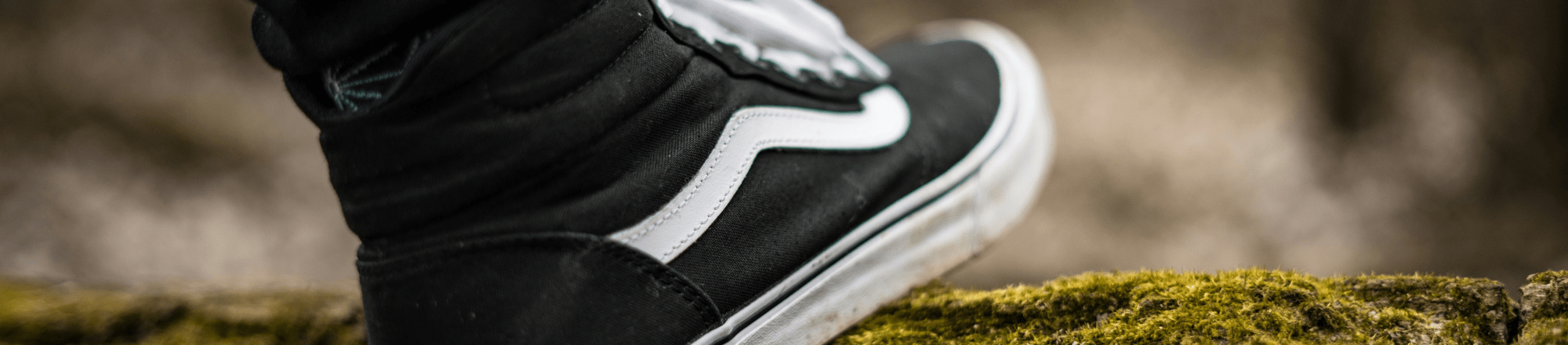 Close up shot of a persons shoe while they are walking in nature