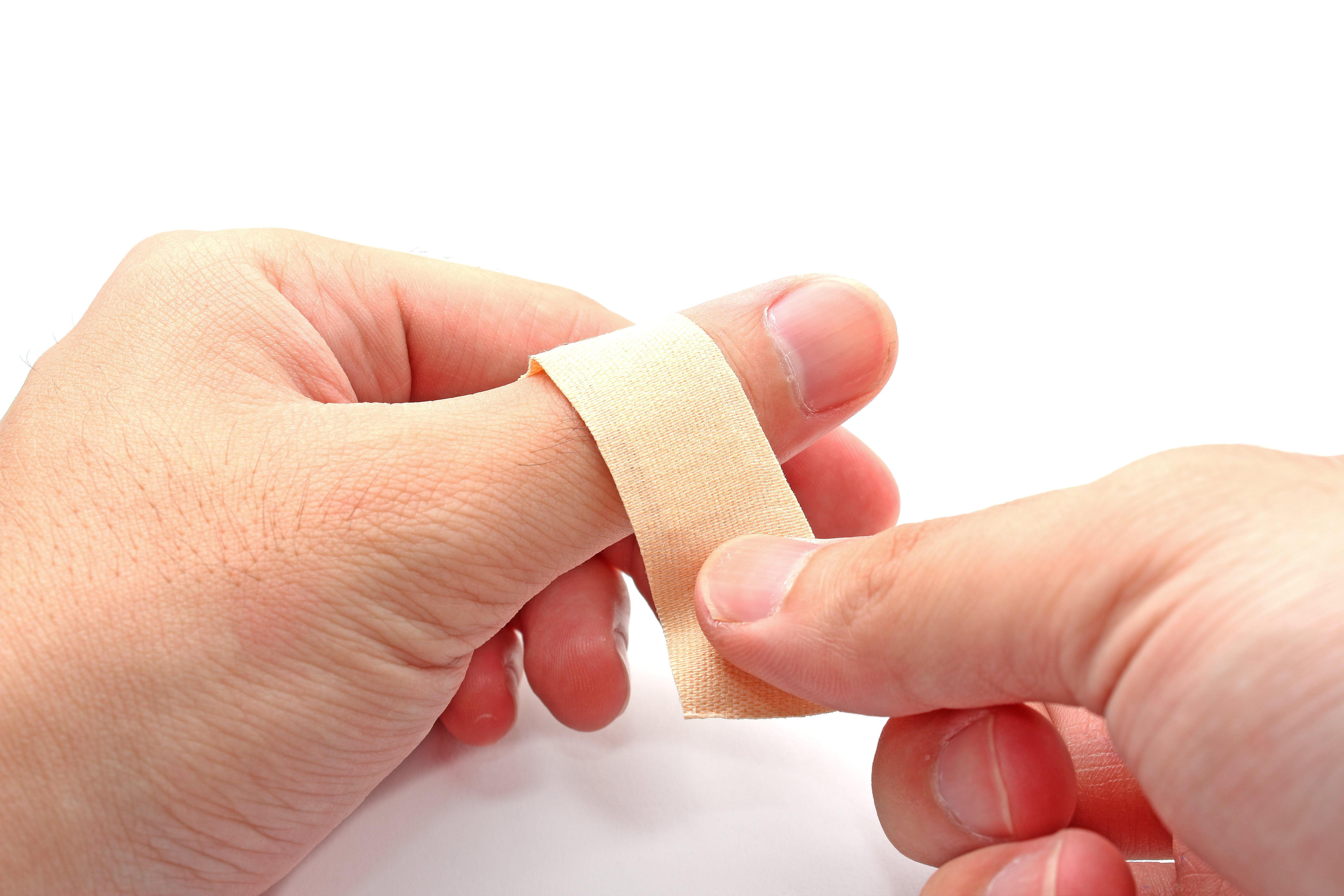 a person putting plaster on a finger