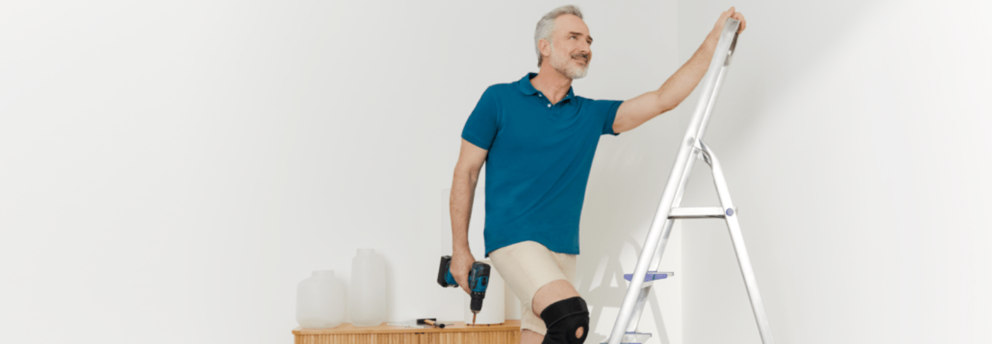 man wearing a knee support at home
