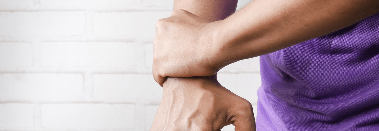 man holding painful wrist