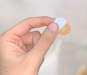 Remove one of the release liners behind the plaster