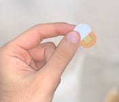 Remove one of the release liners behind the plaster