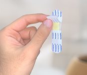 Remove one of the release liners behind the plaster