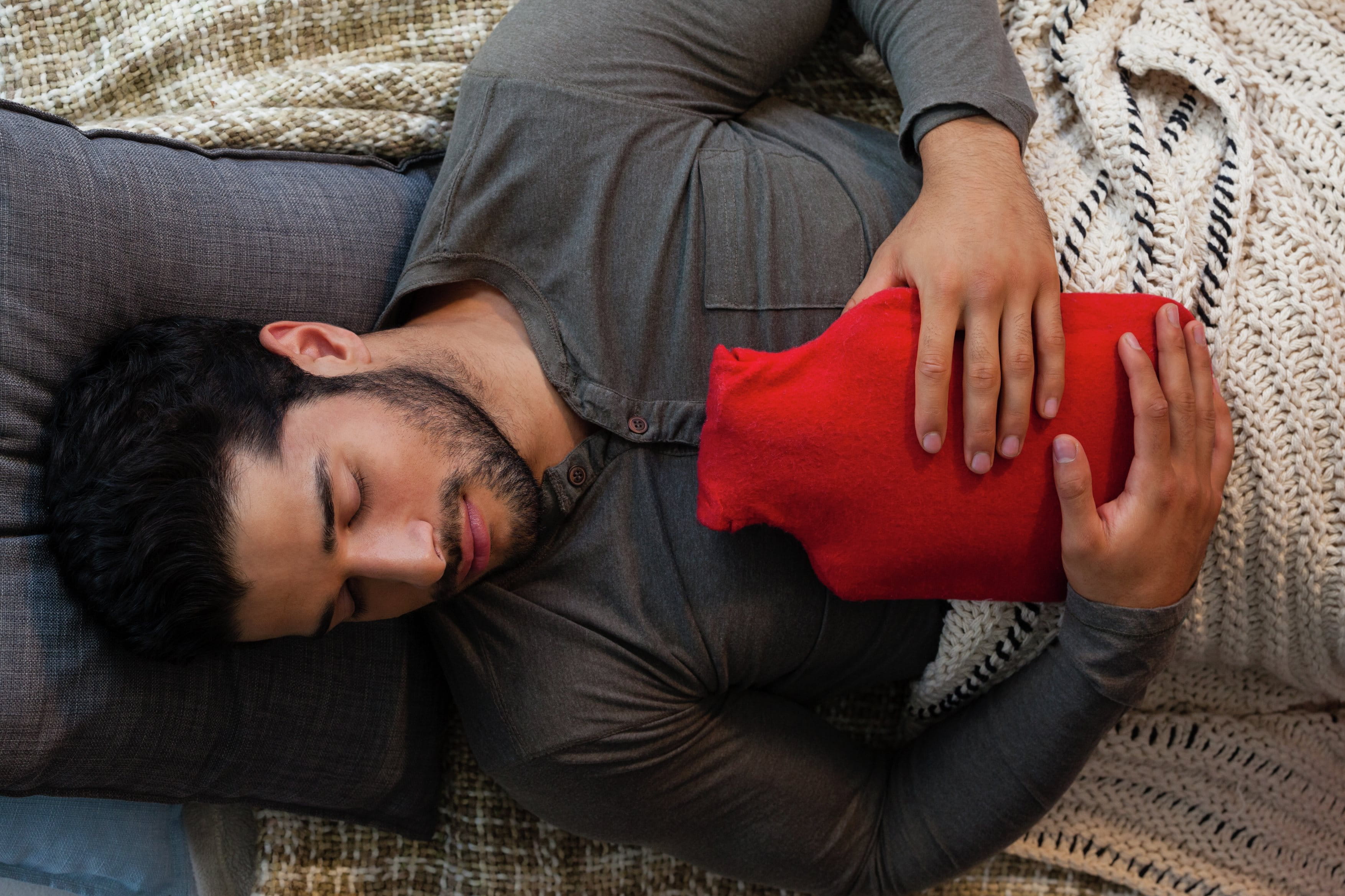 man holding hot water bottle